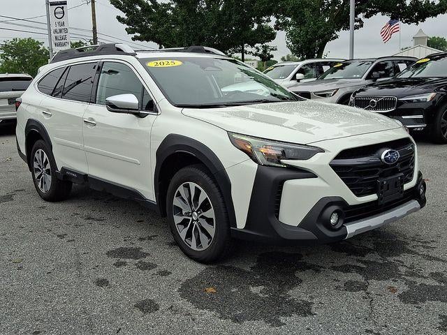 2025 Subaru Outback Touring AWD in Crystal White Pearl — front three-quarter view