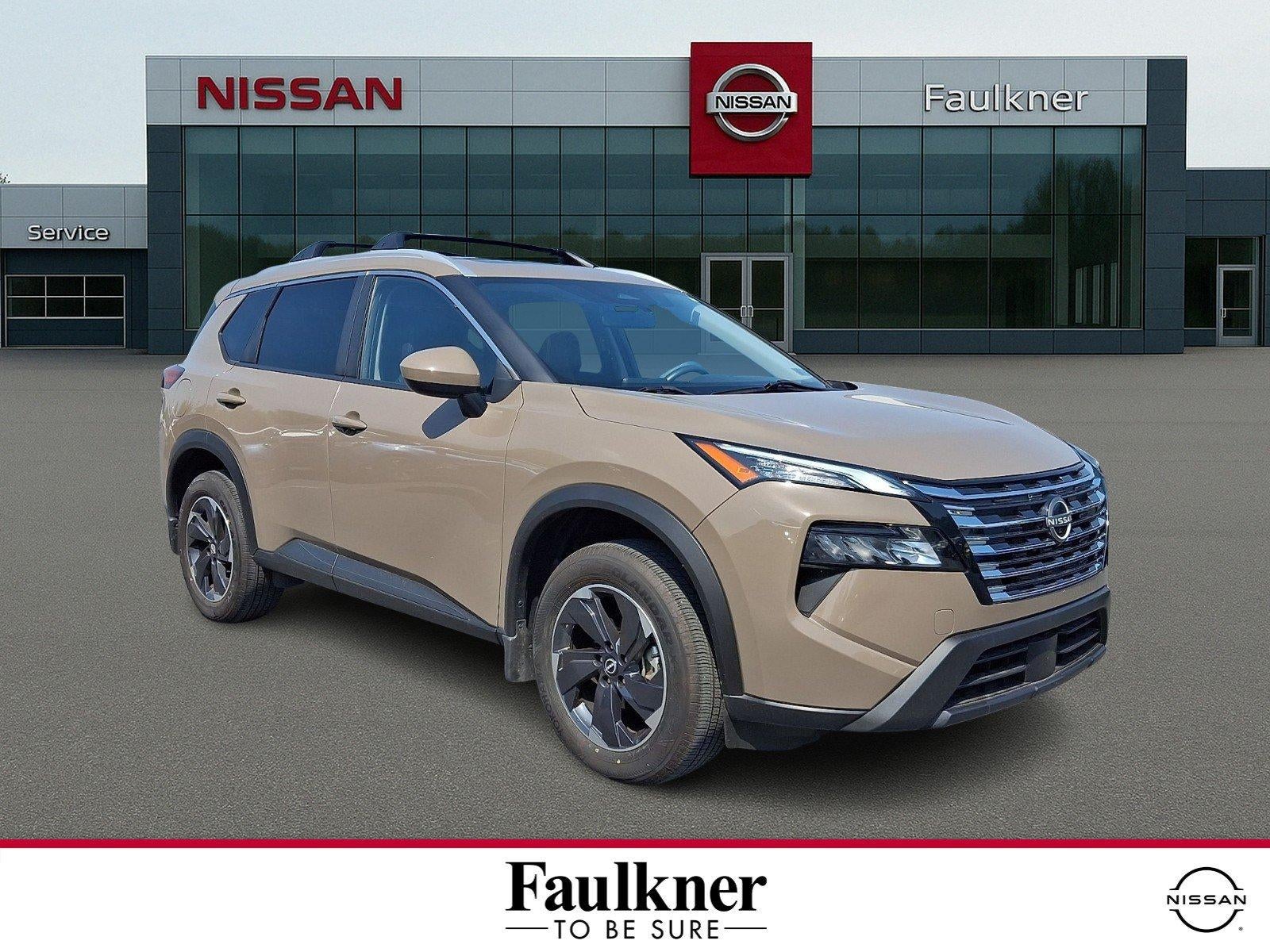 2024 Nissan Rogue SV in Baja Storm — front three-quarter view