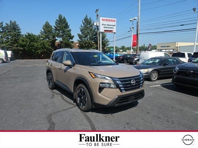 2025 Nissan Rogue SV in Baja Storm — front three-quarter view